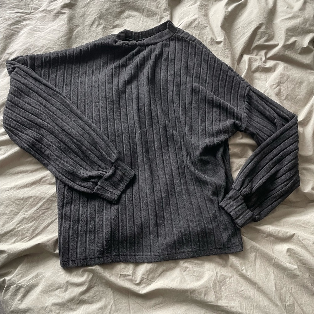 black long sleeve sweater with slightly balloon-like sleeves and a mock neck